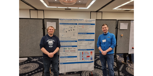 Photo: Kevin Sidak and  Lorenz Kummer in front of their presented poster